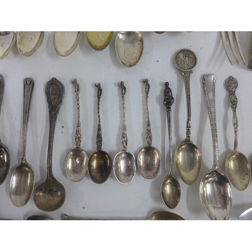 65 - A quantity of silver and white metal souvenir teaspoons, pickle forks, etc (a lot)