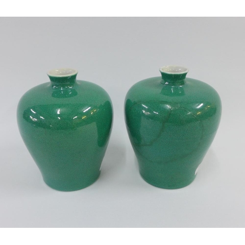 82 - A pair of Chinese apple green glazed meiping vases with a craquelure ground, each with six character... 