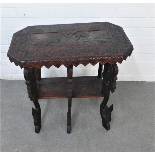 212 - An early 20th century two tier table, the rectangular top with carved elephant and tiger pattern, on... 