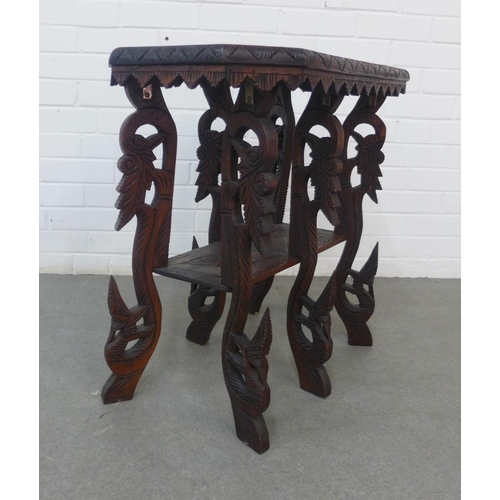 212 - An early 20th century two tier table, the rectangular top with carved elephant and tiger pattern, on... 