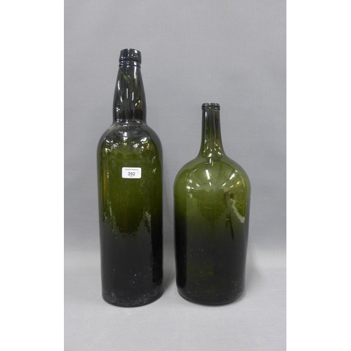 392 - Two large green glass bottles, tallest 56cm (2)