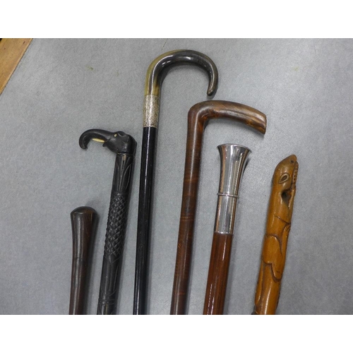 414 - A collection of six late 19th and early 20th century walking canes to include silver mounted, ebonis... 