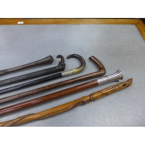 415 - A collection of six late 19th and early 20th century walking canes to include silver mounted, ebonis... 