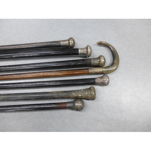 416 - A collection of six late 19th and early 20th century walking canes to include silver mounted, and a ... 