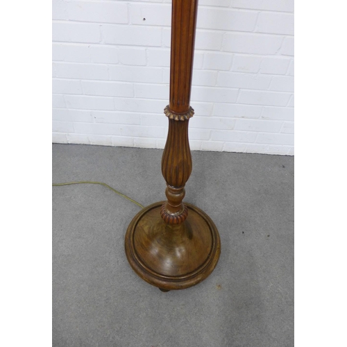 424 - Mahogany standard lamp of fluted design, on a circular base , 188cm high  including shade