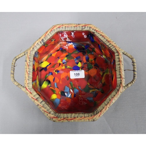 108 - Octagonal glass bowl contained within a basket with handles tot he side, 24cm wide