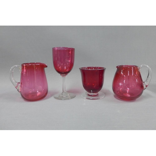 127 - Collection of cranberry glass to include a water jug, various drinking glasses, two small jugs and a... 