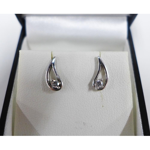 4 - A pair of 9ct white gold and diamond earrings of tear drop shape