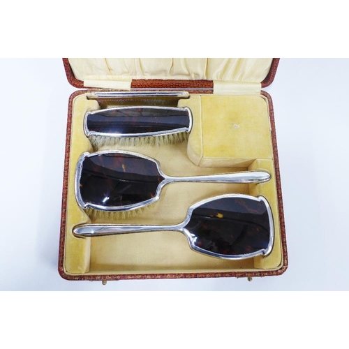 47 - Four piece silver mounted dressing table brush set, Birmingham 1927, in fitted case