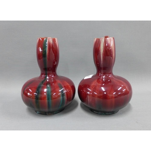 96 - Pair of Christopher Dresser style red glazed jugs, with angular side handle, 20cm (2)