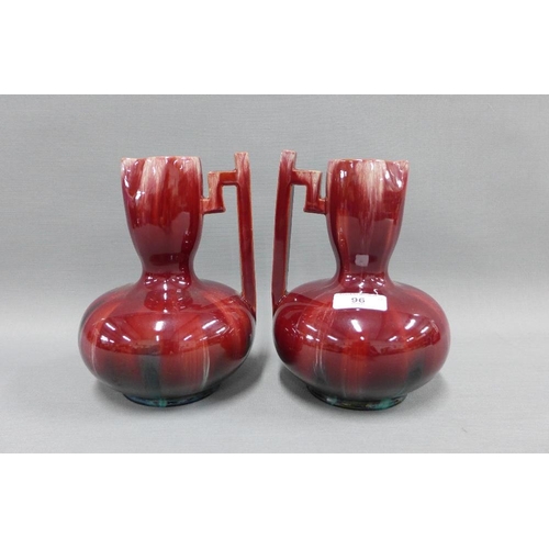 96 - Pair of Christopher Dresser style red glazed jugs, with angular side handle, 20cm (2)