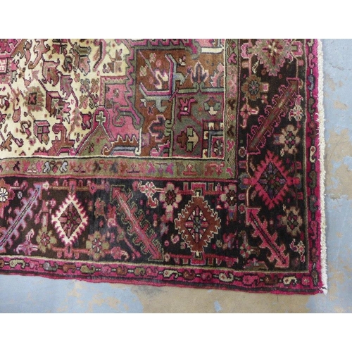 201 - North West Persian Heriz carpet, red field with central medallion, angular foliage and flowerhead bo... 