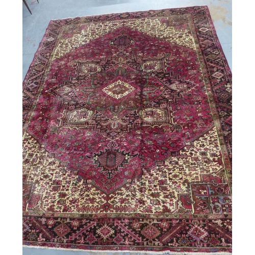 201 - North West Persian Heriz carpet, red field with central medallion, angular foliage and flowerhead bo... 