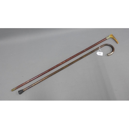 379 - Two early 20th century walking canes,one with a horn handle the other with white metal mounts, (2)