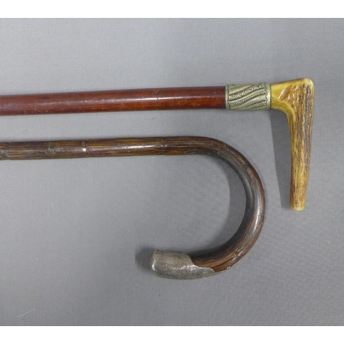 379 - Two early 20th century walking canes,one with a horn handle the other with white metal mounts, (2)