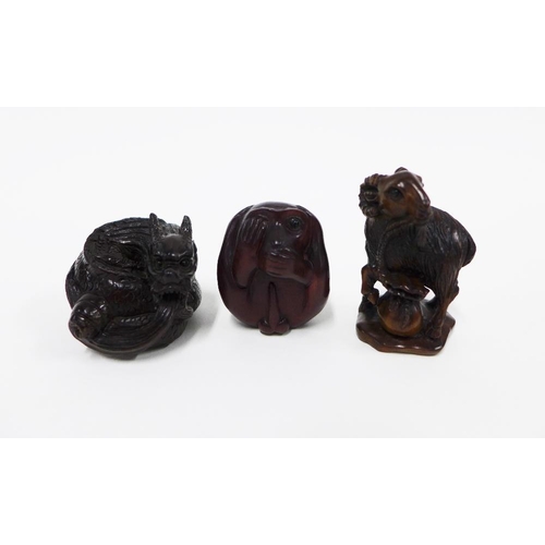 405 - A collection of three wooden netsukes to include a monkey, dragon and ram, tallest 5cm (3)