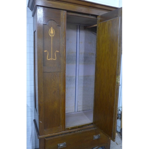 400 - Early 20th century wardrobe with inlaid tulip motifs and a central mirrored door