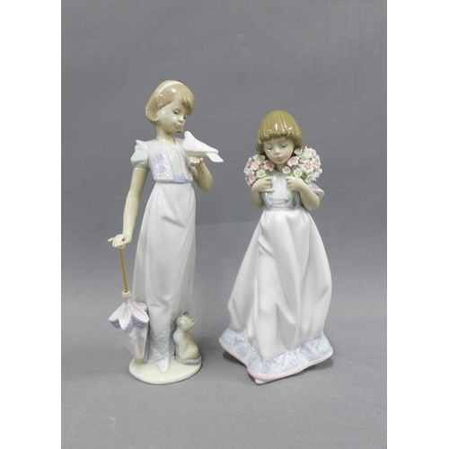 105 - Two Lladro Collector's Society figures to include a girl with an umbrella, cat and bird, signed on t... 