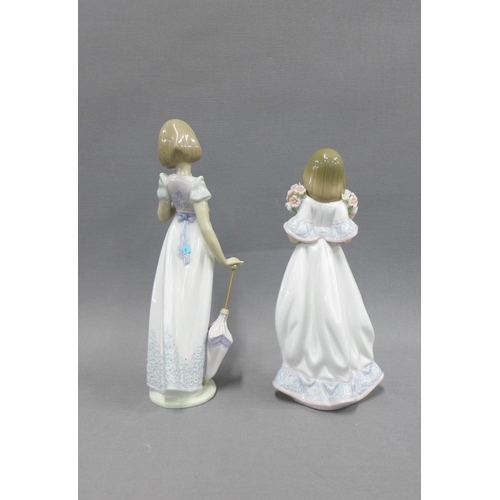 105 - Two Lladro Collector's Society figures to include a girl with an umbrella, cat and bird, signed on t... 