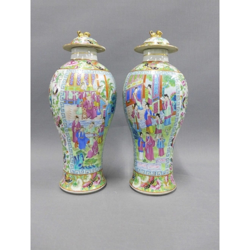 84 - A pair of Chinese famille rose 'Mandarin' lidded baluster vases, typically painted with figures, flo... 