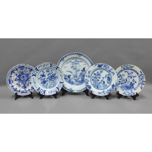 94 - Collection of blue and white tin glazed plates, typically painted with flowers and foliage, some res... 