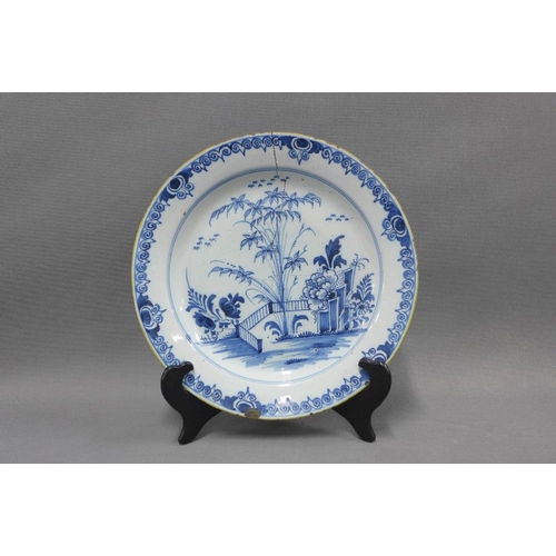 94 - Collection of blue and white tin glazed plates, typically painted with flowers and foliage, some res... 