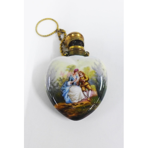 12 - Two scent bottles to include a porcelain heart shaped bottle, painted with figures and a small porce... 