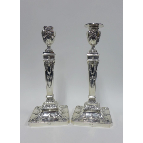 49 - Pair of silver candlesticks, Barker Ellis Silver Co, Birmingham 1965, with repousee classical motifs... 