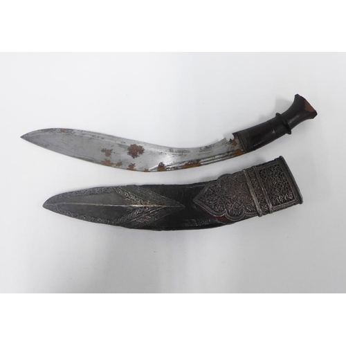 75 - Silver mounted Kukri of traditional form, with a curved steel blade with double fuller and wooden ha... 