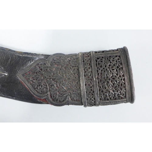 75 - Silver mounted Kukri of traditional form, with a curved steel blade with double fuller and wooden ha... 