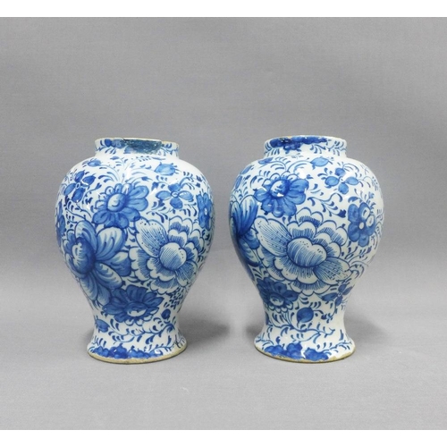 81 - Pair of antique Delft blue and white floral patterned vases, (a/f with restorations) 18cm (2)