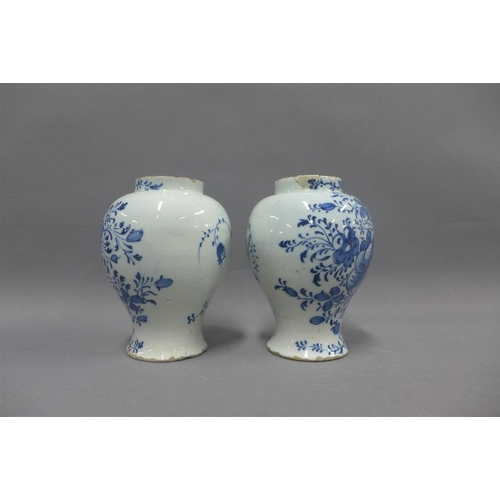 81 - Pair of antique Delft blue and white floral patterned vases, (a/f with restorations) 18cm (2)