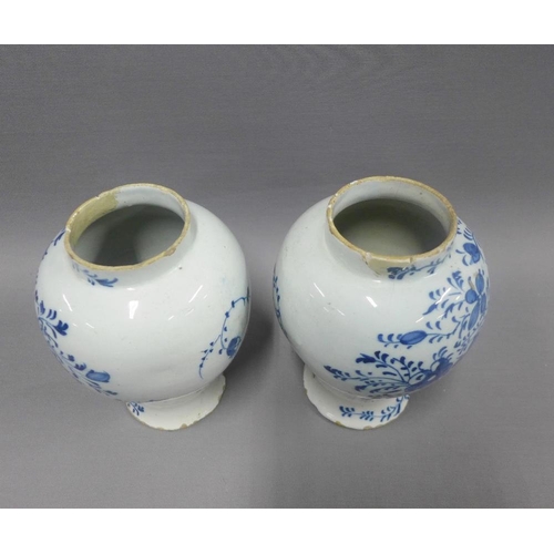 81 - Pair of antique Delft blue and white floral patterned vases, (a/f with restorations) 18cm (2)