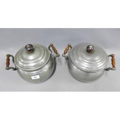 405 - Two early 20th century cooking pots and covers with wooden finials (2)