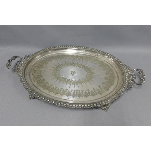 77 - A large silver plated tray with a family crest to centre and engraved pattern, handles to side and b... 