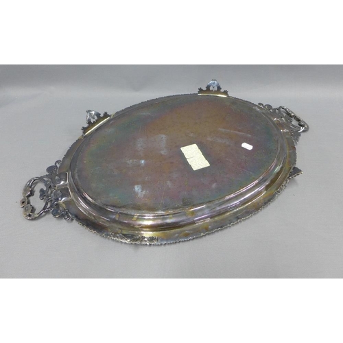 77 - A large silver plated tray with a family crest to centre and engraved pattern, handles to side and b... 