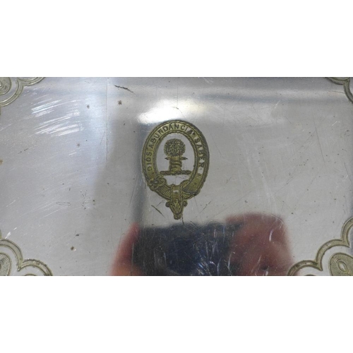 77 - A large silver plated tray with a family crest to centre and engraved pattern, handles to side and b... 