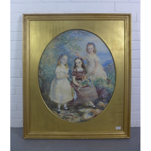 117 - Large watercolour of three girls in a garden picking flowers, in an oval gilt mount and framed under... 