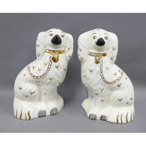 104 - A pair of Beswick chimney spaniels, with painted eyes and gilded collar and chain, impressed marks, ... 