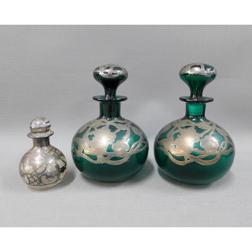 106 - A pair of silver overlaid green glass scent bottles with stoppers and another smaller scent bottle (... 