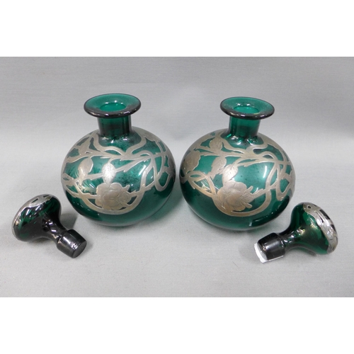 106 - A pair of silver overlaid green glass scent bottles with stoppers and another smaller scent bottle (... 