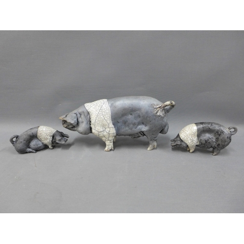 116 - Raku glazed Saddleback pig, signed indistinctly, 27cm long (ear restored)and two smaller pigs (3)