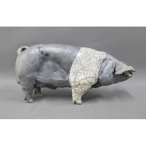 116 - Raku glazed Saddleback pig, signed indistinctly, 27cm long (ear restored)and two smaller pigs (3)