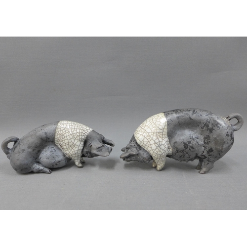 116 - Raku glazed Saddleback pig, signed indistinctly, 27cm long (ear restored)and two smaller pigs (3)