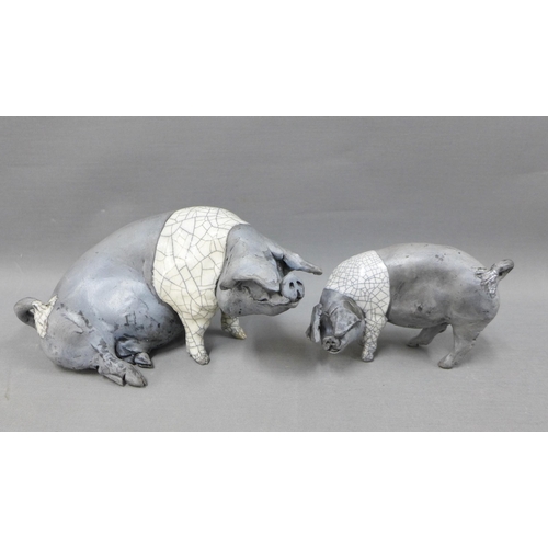 117 - Raku glazed Saddleback Sow, modelled sitting, 23cm long, together with a smaller pig, signed indisti... 