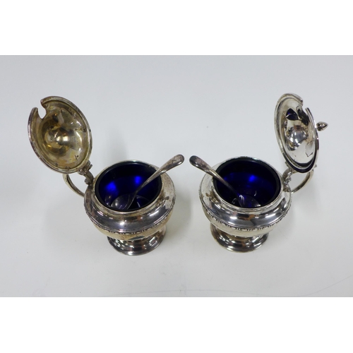 30 - A pair of George V silver mustard condiments with blue glass liners, pair of plated salt spoons, Che... 