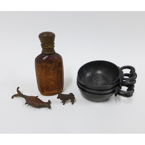 328 - Small leather clad bottle, 11cm and four French pewter vin de taste, miniature bronze dog, 1.5cm and... 