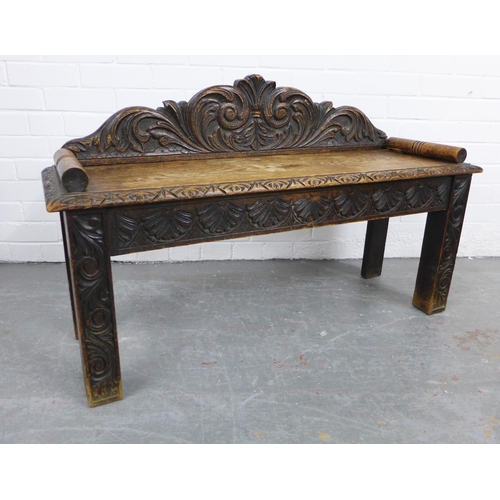 334 - Carved oak window seat with a scrolling toprail, solid seat and straight square legs, 107 x 65cm