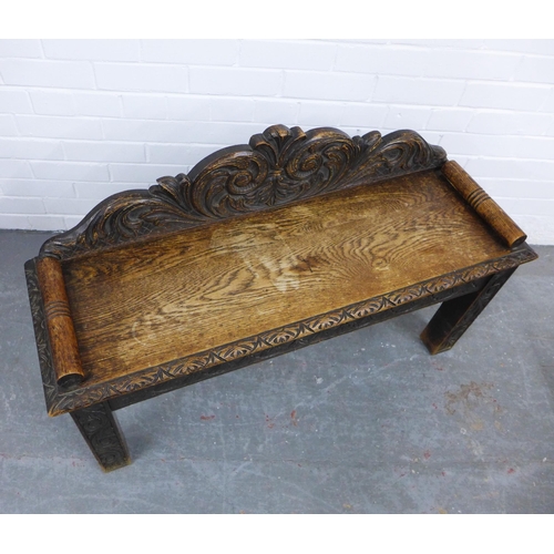 334 - Carved oak window seat with a scrolling toprail, solid seat and straight square legs, 107 x 65cm