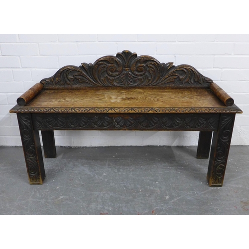 334 - Carved oak window seat with a scrolling toprail, solid seat and straight square legs, 107 x 65cm